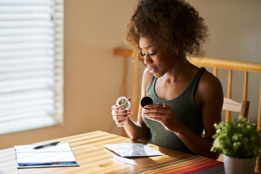 Woman at home with cannabis delivery sitting at table
