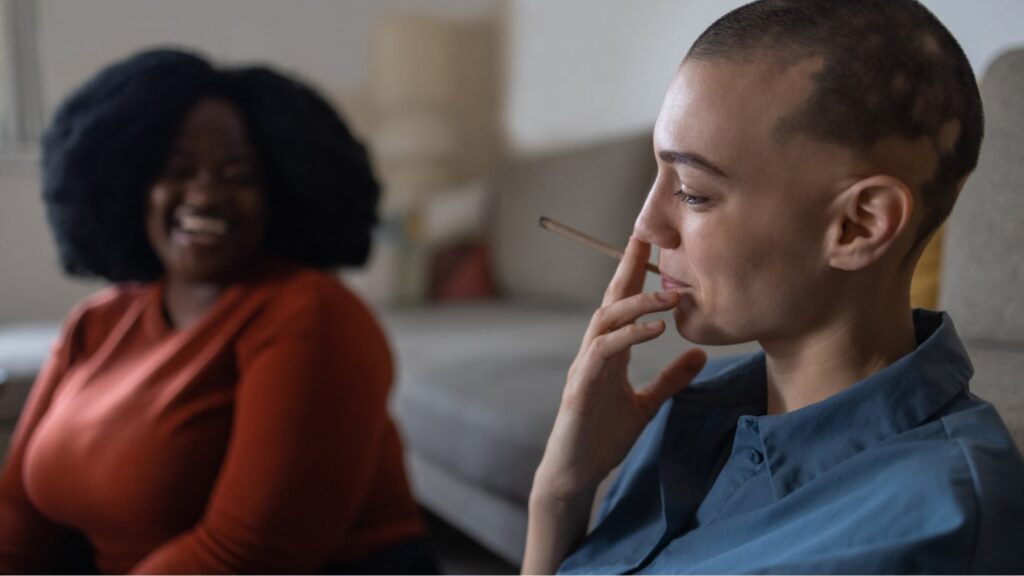 Two women smoking cannabis at home in MA 