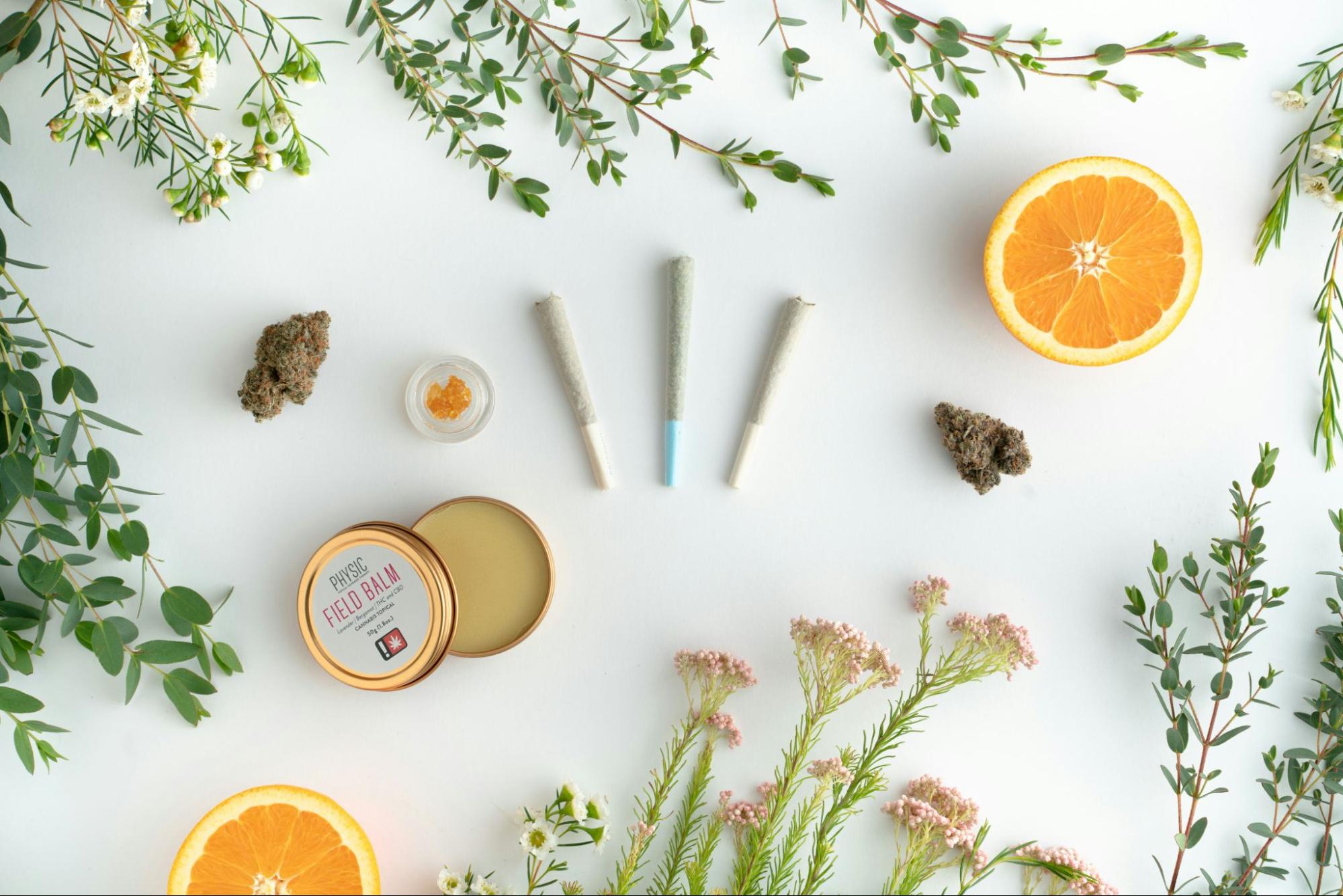 Cannabis products displayed among citrus and other terpene-rich plants