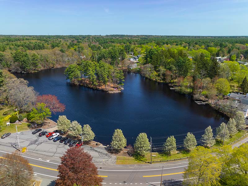 Photo of Johnson Pond aerial view on Forge River in spring at the historic center of Raynham, Bristol County, Massachusetts MA, USA. Photo uses to represent Rahnam in this section about raynham weed delivery.